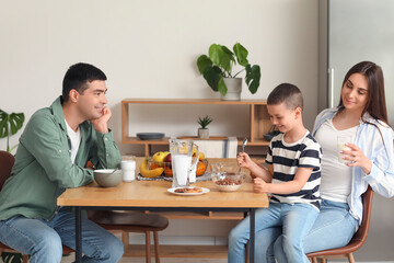 Sticker - Little boy with his parents having breakfast in kitchen