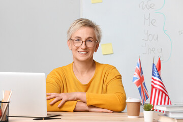 Canvas Print - Female English teacher giving online lesson in classroom