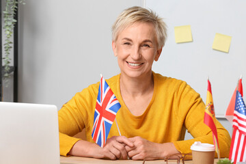 Canvas Print - Female English teacher with UK flag in classroom