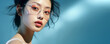© elovich - Close-up portrait of a young Asian woman wearing glasses