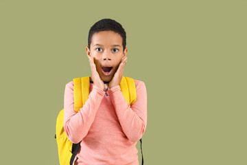 Sticker - Surprised African-American boy with school backpack on green background