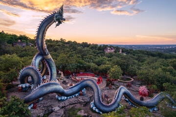 Phaya Si Mukda Maha Muni Nilapala Nakkharat The King of giant Naga statue at Wat Phu Manorom in sunset,Mukdahan Province Thailand.