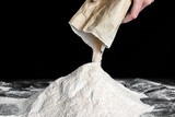 Fototapeta Lawenda - Chef pouring flour on table. Preparing dough for bread or pizza.