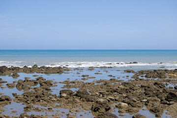 Poster - Sea rock reef with blue sky