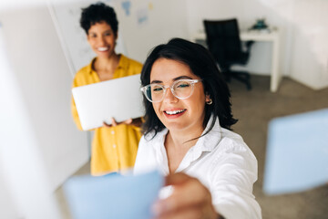 Business woman lays out her ideas using sticky notes