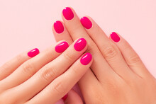 Close up beautiful womans hands with pink nail design. Manicure, pedicure beauty salon concept