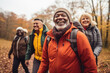 © Maria - Diverse group of active senior people walking outdoors hiking in autumn park.