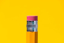 Bright Yellow Pencil With Eraser On Top In Blue Studio