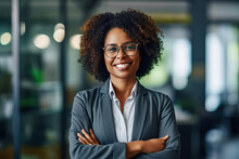 A Smiling  Business Afro Woman Ceo Wearing Glasses Happy Middle Aged Business Woman Ceo Standing In Office With Arms Crossed. Smiling Mature Confident Professional Executive Manager, Proud Lawyer, Bus