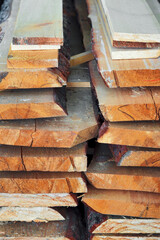 New planed wooden boards stacked in sawmill. Procurement and sale of building material. Dry wood. Woodworking. Background.