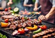 Barbeque grill with delicious grilled meat and vegetables on blurred party background
