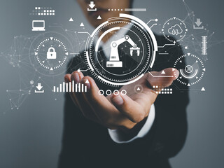 Wall Mural - robotic arm in manufacturing industry. digital. businessman examining the operation of an automated 