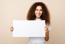 Happy Young Woman Holding Blank White Banner Sign, Isolated Studio Portrait .