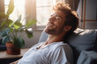 © wolfhound911 - Satisfied handsome young man relaxing on the sofa at home, Smiling men enjoying day off lying on the couch, Healthy lifestyle, people and holiday concept.