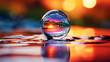 A water drop reflecting a colorful scene