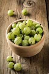 Wall Mural - Fresh gooseberry in a wooden bowl.