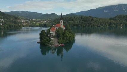 Wall Mural - Aerial view of Church of the Assumption of Mary in the center of the lake Bled. Flying to small island on Bled Lake in Slovenia.