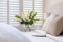 Selective Focus On Luxury White Indoor Plantation Shutters In Bedroom.