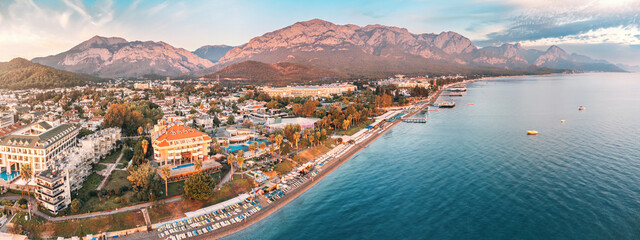 Wall Mural - awe-inspiring aerial panorama of Kemer, Turkey, featuring luxurious hotels and majestic mountains in the backdrop.