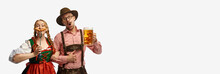Banner. Amicable Friends. Full Lenght Portrait Of Friendly Man And Woman Wearing Folk Festival Outfits With Bavarian Beer Glasses And Tasty Sausages.