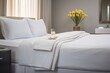 © OMD - crisp white hotel-style bed with folded towels