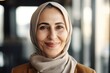 © NikoG - Middle aged arab businesswoman with a hijab smiling in a modern office