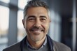 © CojanAI - Middle aged businessman of latin ethnicity smiling in a modern office