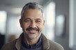© CojanAI - Middle aged businessman of latin ethnicity smiling in a modern office