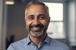 © CojanAI - Middle aged businessman of latin ethnicity smiling in a modern office