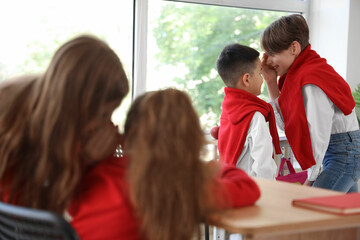 Canvas Print - Little boys gossiping in classroom