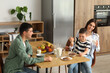 © Pixel-Shot - Little boy with his parents having breakfast in kitchen