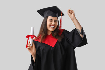 Sticker - Happy female graduate student with diploma on light background