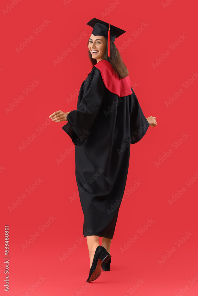 Female graduate student on red background