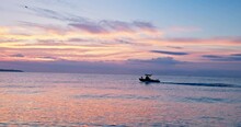 Summer Sea Sunrise And Sailing Patrol Or Fishing Motor Boat Early In The Morning Sail On The Sea Water, Nature Seascape 4K Video