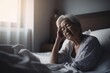 © Baba Images - Senior woman having a headache and feeling sick in the bedroom at home