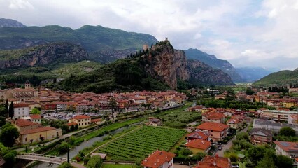 Wall Mural - Landmarks of northern Italy. Lago di Garda lake. scenic Arco medieval village with impressive castle' ruins on the rock. aerial drone video