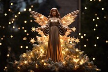 Christmas Tree Topper Christmas Angel Decoration Element. Sits Atop The Christmas Tree, Illuminated By Surrounding Lights