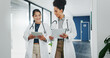 © SneakyPeakPoints/peopleimages.com - Talking doctors, walking or tablet in busy hospital, teamwork or collaboration for surgery planning, medicine or life insurance app. Smile, happy or planning healthcare women on technology research