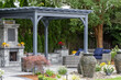 Landscape architecture featuring pergola and stone fireplace with stone urn water fountains