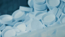 Lots Of White Plastic Caps. Production Line Of Medical Dietary Supplements. Pharma Factory