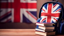 Student's Backpack, Books And The Flag Of Great Britain On The Background. The Concept Of Advertising, Banner: Language Courses Or Studying At A University In The UK. Copy Space.