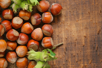 Wall Mural -  Hazelnuts on a wooden table.Nut abundance. Fresh harvest of hazelnuts. organic ripe hazelnuts. 