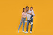 © New Africa - Portrait of happy family on orange background
