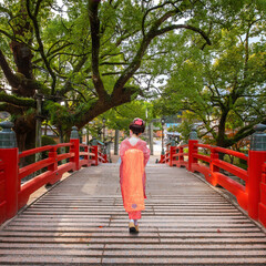 Sticker - A Japanese Geisha in Traditional Kimono Dress on the Bridge to Dazaifu Tenmangu  Shrine in Fukuoka, Japan