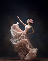 Wall Mural - A porcelain figurine elegantly contrasts a graceful lady in a flowing gown with a dark backdrop.