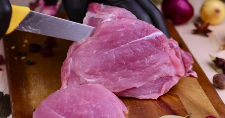 Wall Mural - a soft boneless part of pork while slicing for cooking, Cut into pieces a piece of pork neck