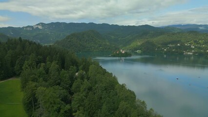 Wall Mural - Aerial view of Church of the Assumption of Mary in the center of the lake Bled. Flying to small island on Bled Lake in Slovenia..