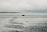 Fototapeta Tęcza - motor boat out at sea in the mist in Sweden