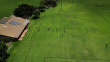 Soccer Players Entering Perth City Field In Australia For Amateur Football Match. Aerial Drone Circling View