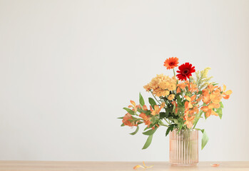 autumn bouquet on wooden shelf on background gray wall